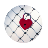 Round icon of a chain-link fence with a red heart lock hanging from it.